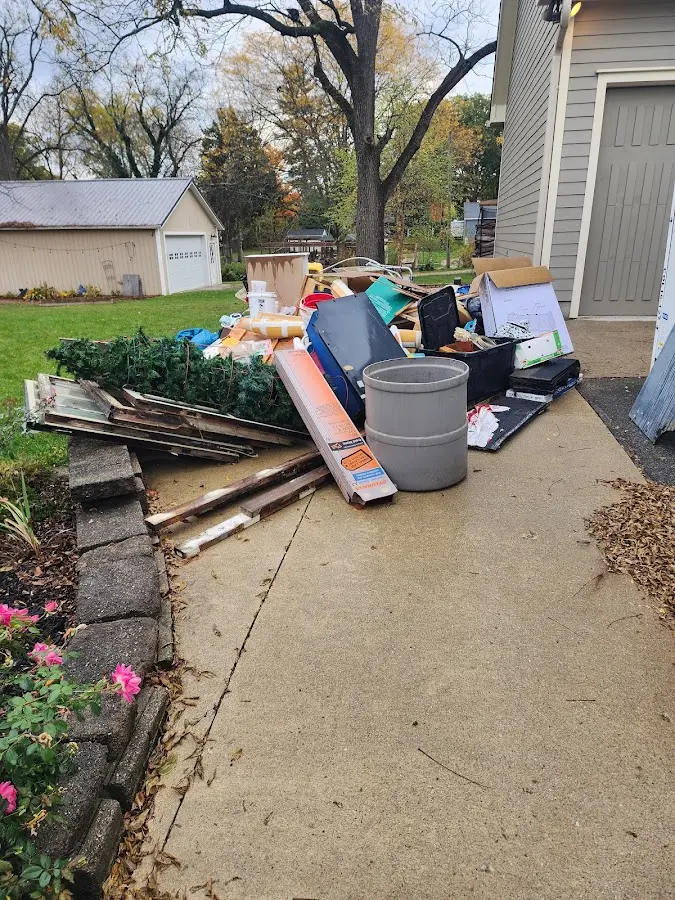 Dumpster being loaded with debris for 3 Yard Dumpster Rental in Lynnfield